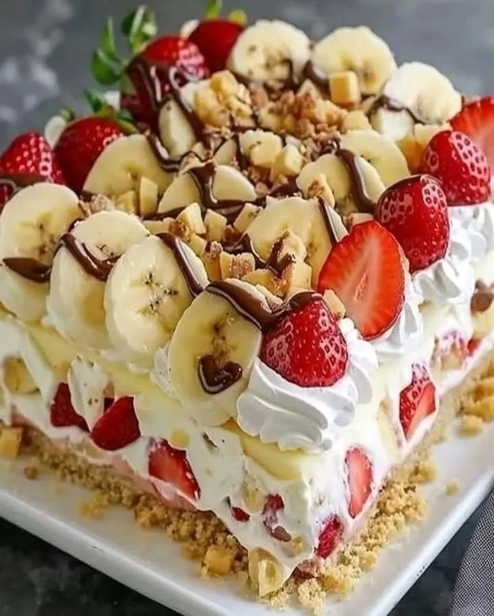 Delicious homemade Banana Split Cake topped with whipped cream and banana slices.