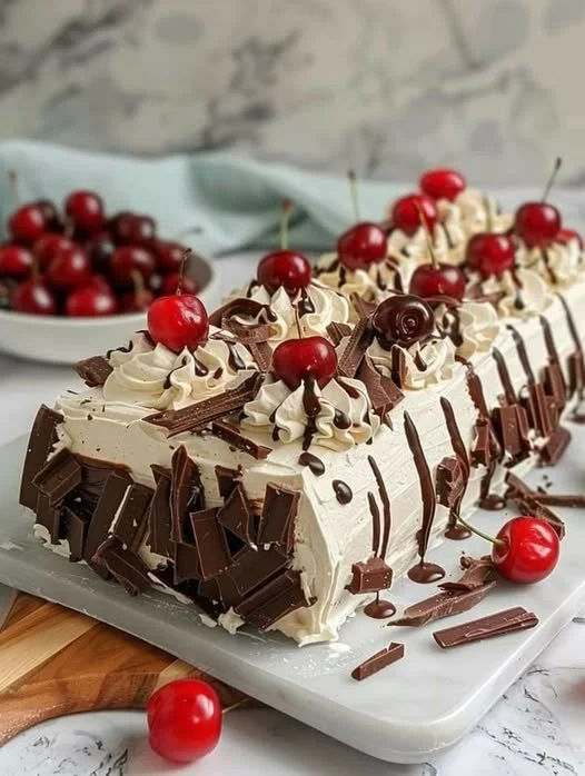Delicious Black Forest Roll Cake with chocolate, cherries, and whipped cream filling