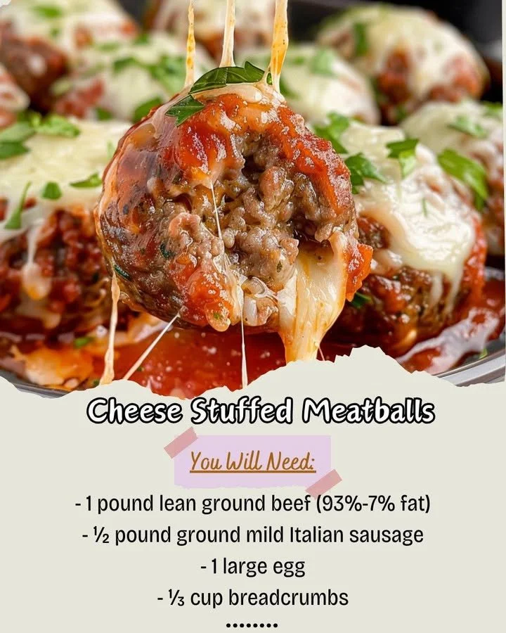 Cheese stuffed meatballs served on a plate garnished with herbs.
