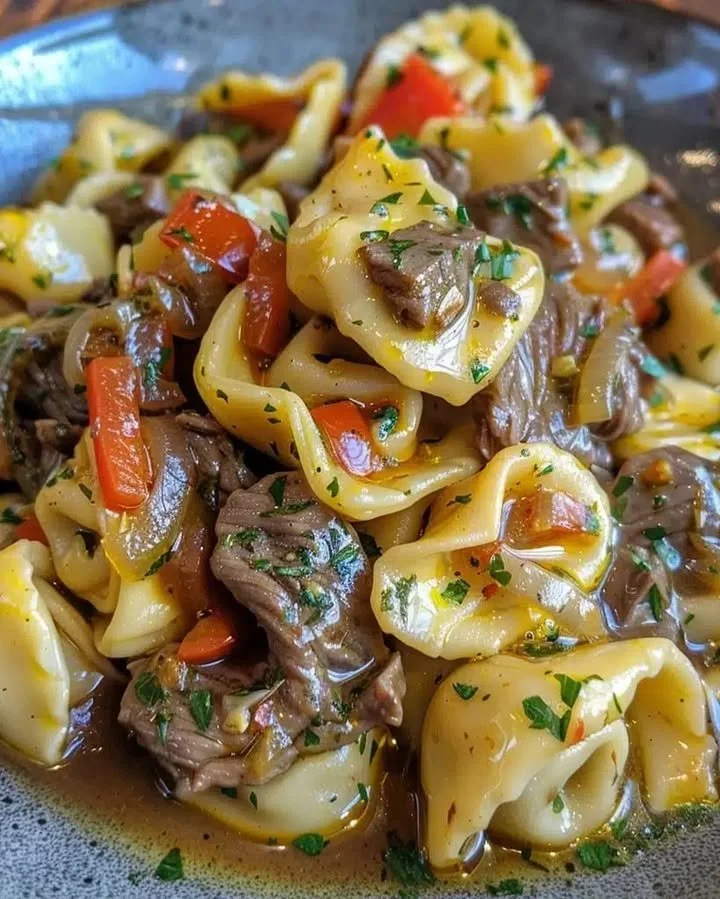 Cheesesteak Tortellini served in creamy provolone sauce