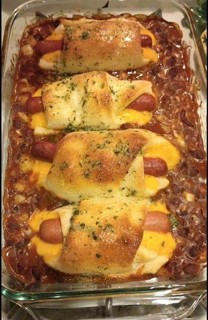 Chili Cheese Dog Bake with melted cheese and chili sauce on hot dogs