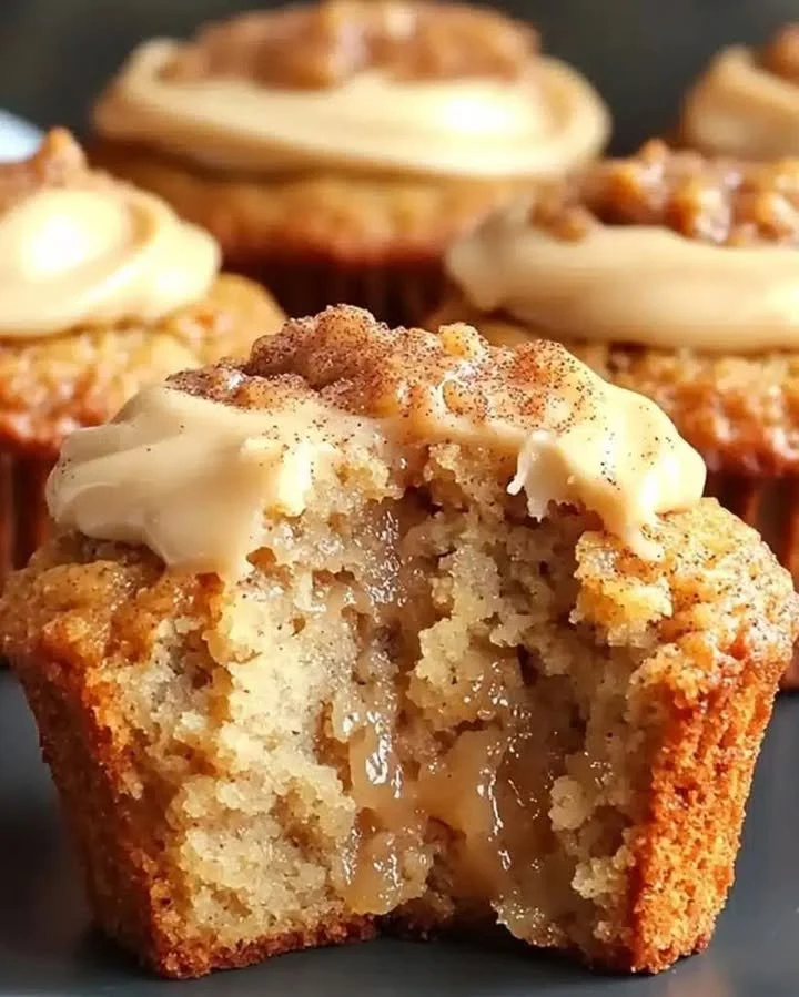 Freshly baked Cinnamon Applesauce Muffins on a rustic wooden table