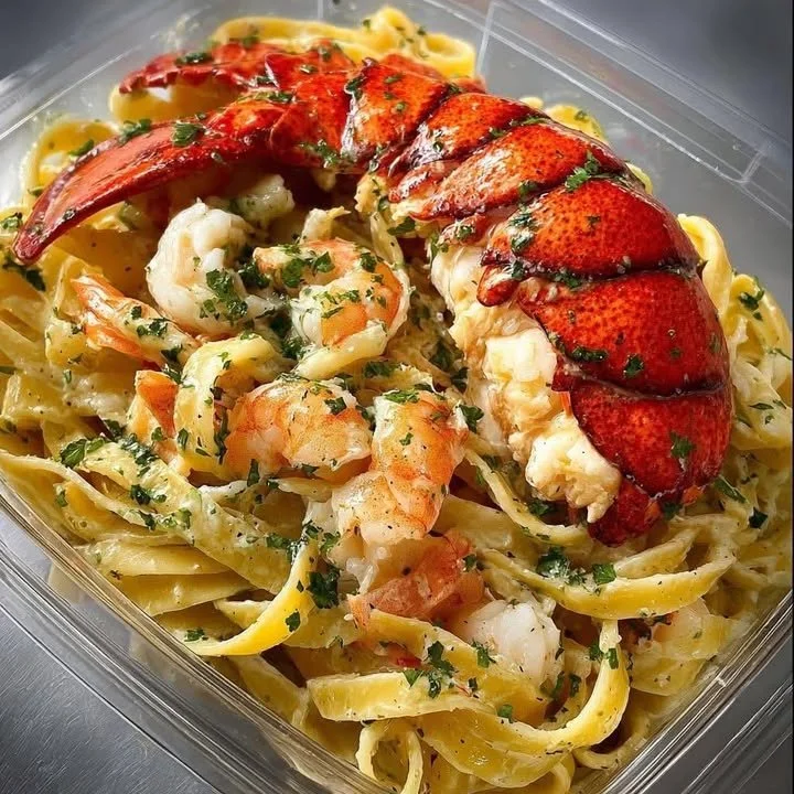 Creamy seafood fettuccine dish with shrimp, scallops, and sauce