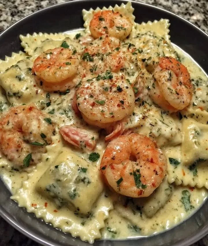 Creamy shrimp parmesan ravioli served with sauce and herbs