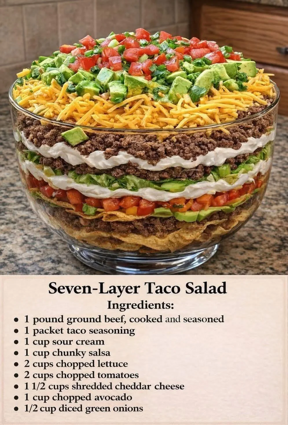 Famous 7 Layer Taco Salad layered with beans, lettuce, tomatoes, and cheese