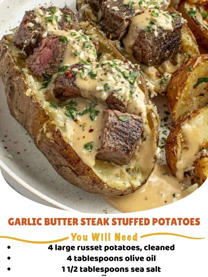 Garlic butter steak stuffed potatoes topped with fresh herbs.