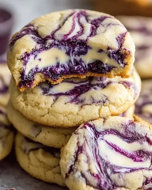 Plate of irresistible blueberry cheesecake cookies with blueberries and cream cheese