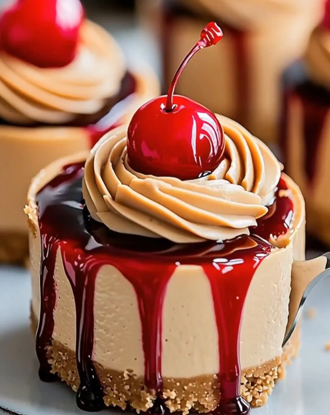 Delicious mini cherry peanut butter cheesecakes topped with fresh cherries.
