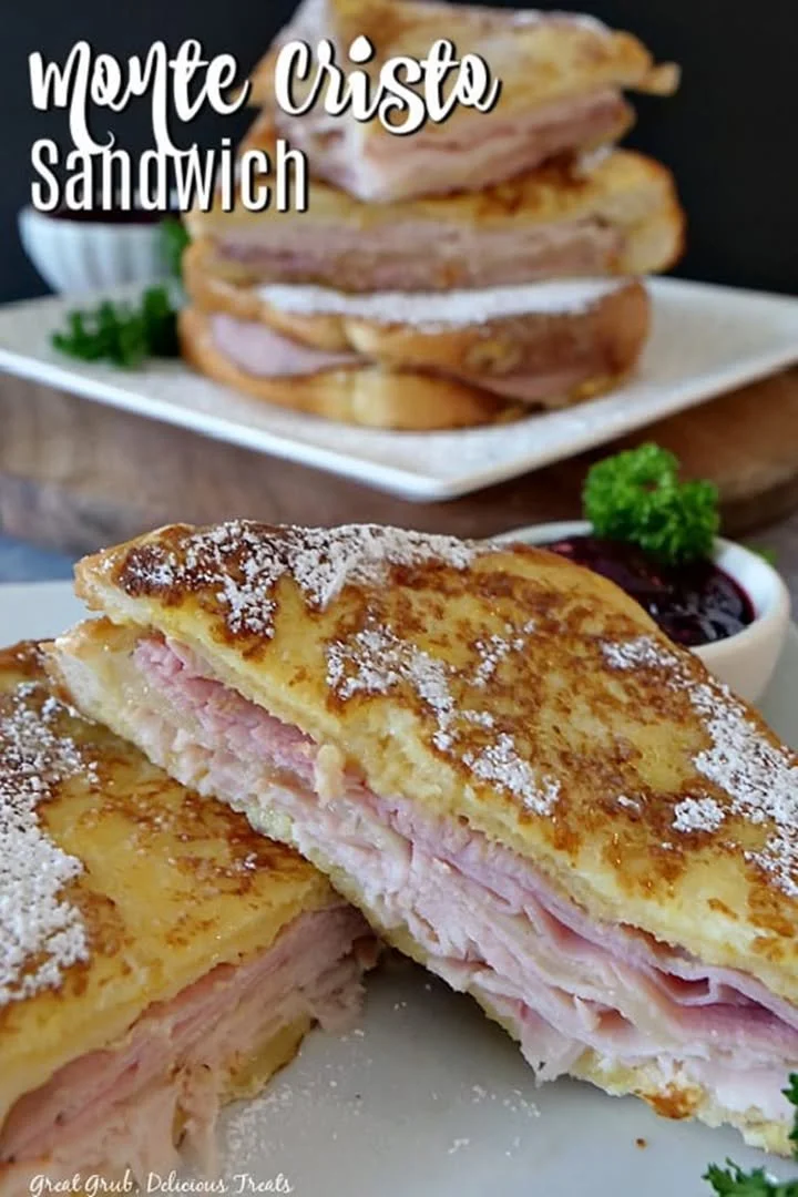 Delicious Monte Cristo sandwich with ham, turkey, and cheese, served with powdered sugar.