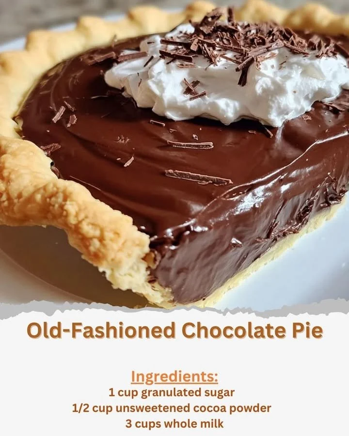 Slice of old-fashioned chocolate pie on a dessert plate with whipped cream