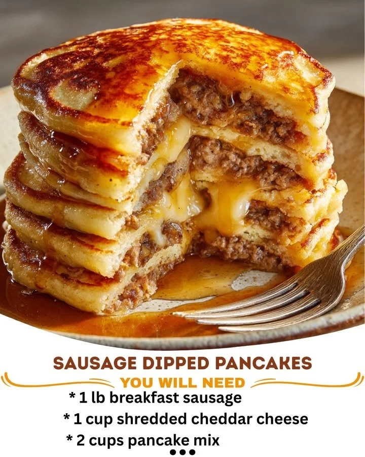 Sausage dipped pancakes served with syrup and fresh berries on a plate