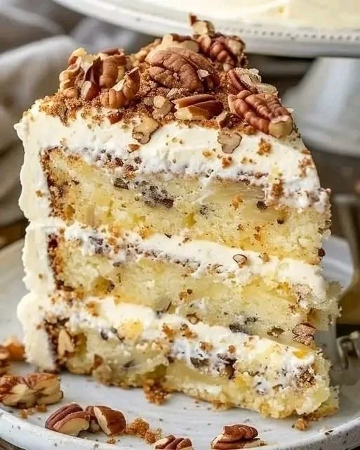 Delicious Southern Creamy Pineapple Pecan Cake topped with pecans and pineapple
