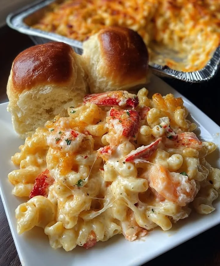 Delicious lobster mac and cheese topped with shrimp and breadcrumbs.
