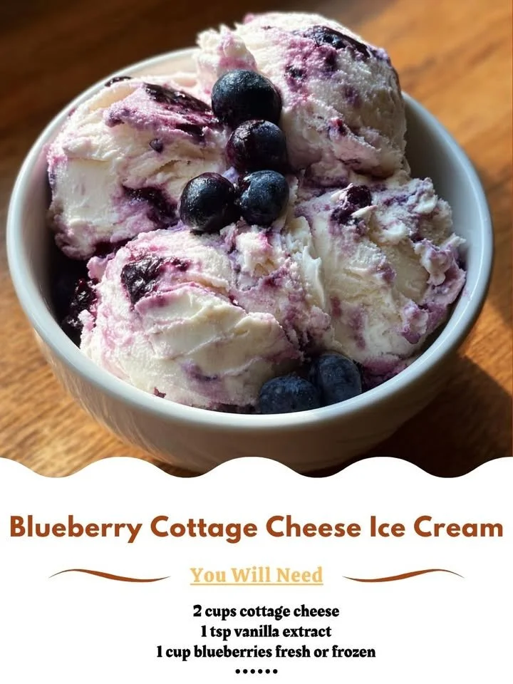 Blueberry cottage cheese ice cream in a bowl topped with fresh blueberries