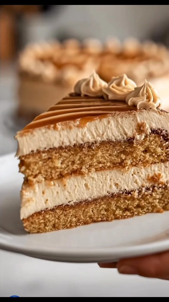 Delicious caramel cream dessert in a glass dish topped with whipped cream.