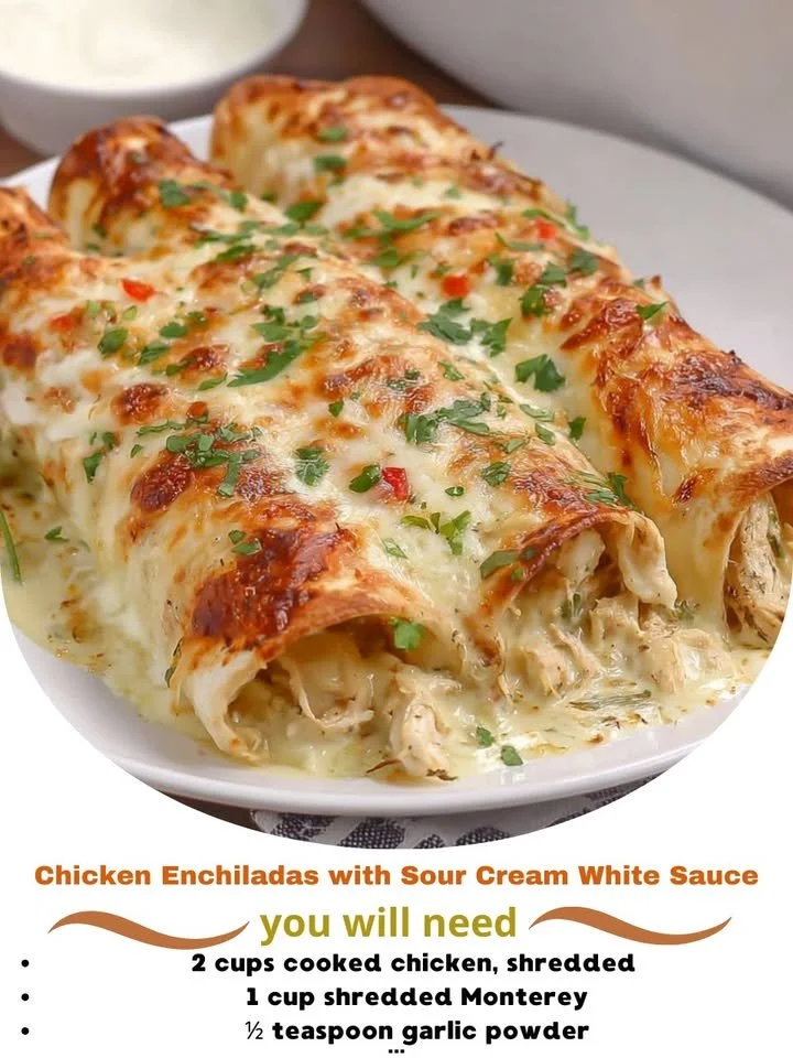 Delicious Chicken Enchiladas topped with sour cream white sauce and garnished.