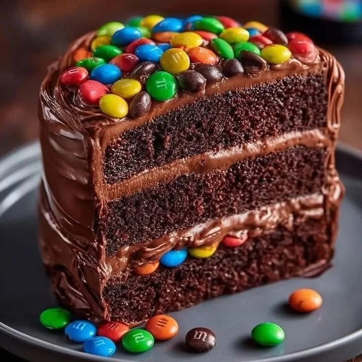 Delicious Chocolate M&M Celebration Cake topped with colorful M&Ms