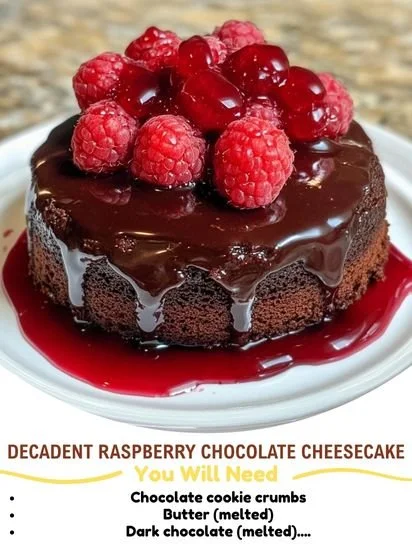 Decadent raspberry chocolate cheesecake topped with fresh raspberries and chocolate drizzle