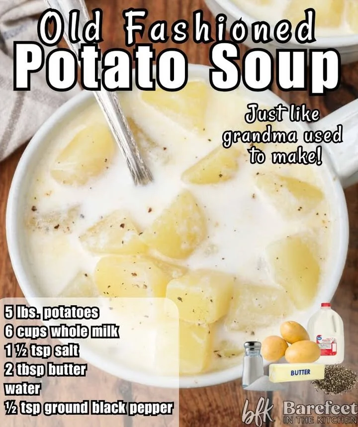 Bowl of creamy homemade potato soup garnished with herbs and served with bread