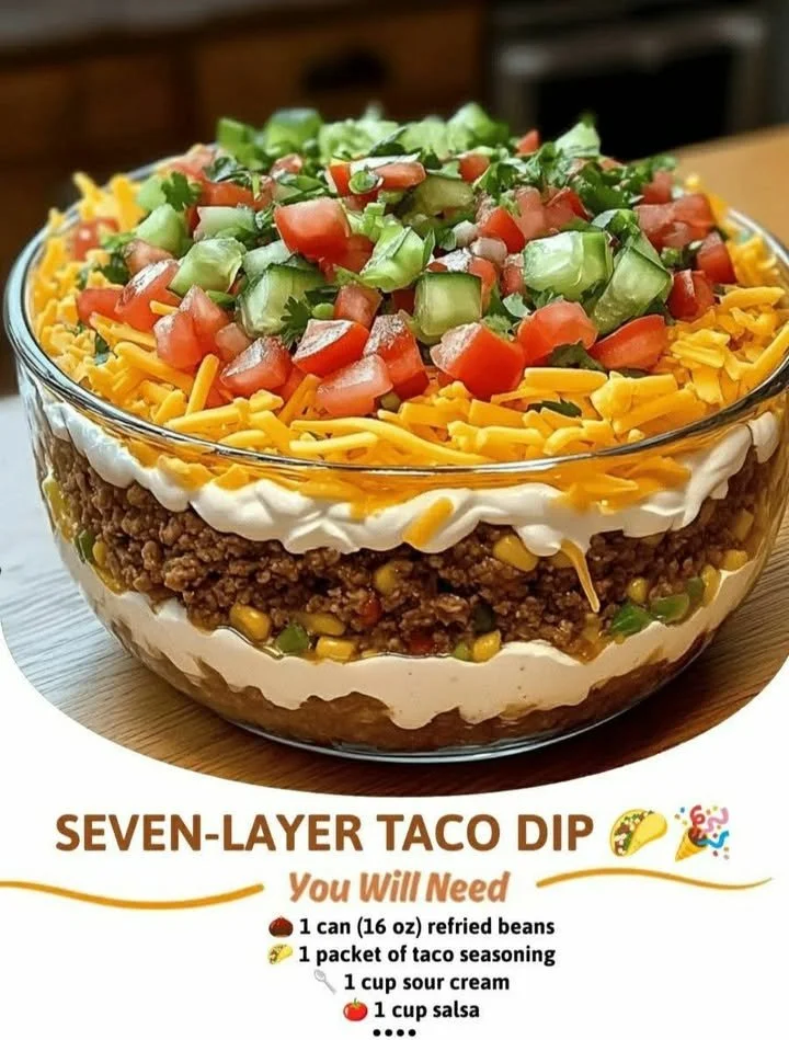 Seven-layer taco dip with beans, cheese, and toppings served in a bowl