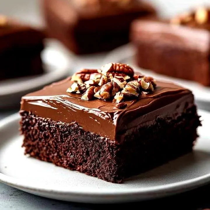 Delicious Texas Sheet Cake with chocolate frosting on a wooden table