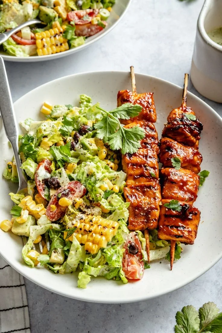 BBQ chicken skewer salad with grilled chicken, fresh greens, and vibrant vegetables