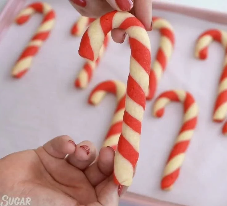Festive candy cane cookies decorated with red and white icing