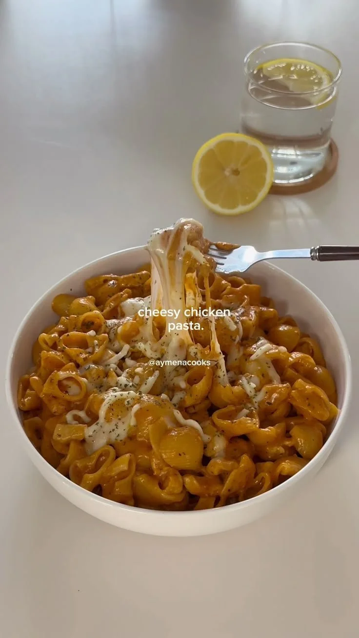 Cheesy chicken pasta dish with creamy sauce and herbs