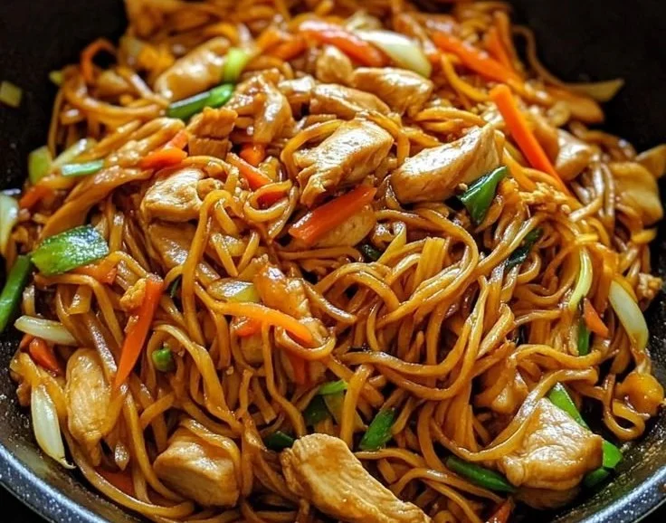 A colorful plate of Chicken Lo Mein with vegetables and noodles