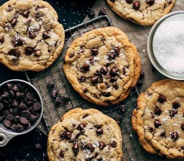 Freshly baked chocolate chip cookies on a cooling rack