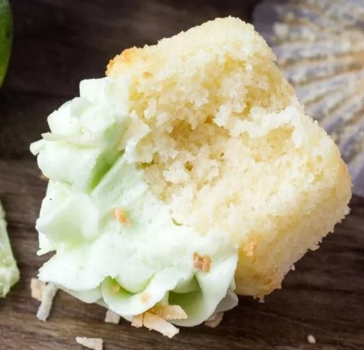 Coconut cupcakes with lime buttercream frosting on a decorative plate