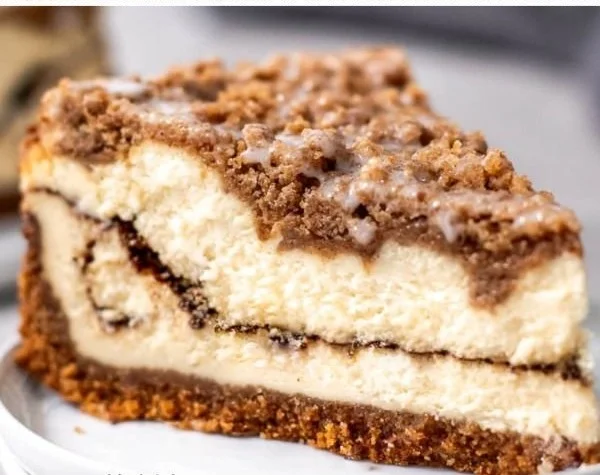 Slice of coffee cake cheesecake topped with crumbled coffee cake