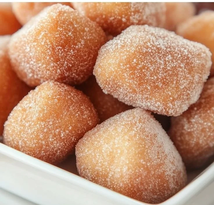 Plate of crispy air fryer churro bites dusted with cinnamon sugar