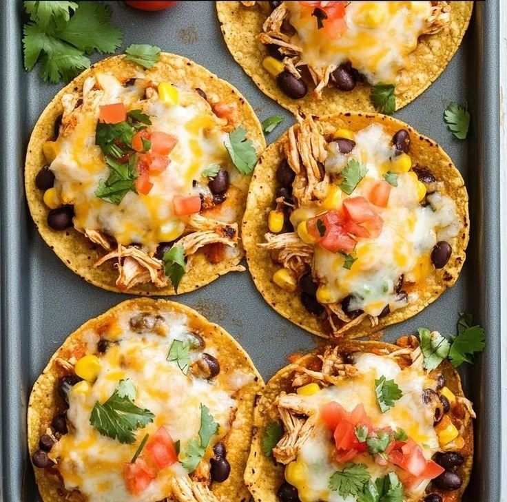 Crispy rotisserie chicken tostadas topped with fresh vegetables and salsa