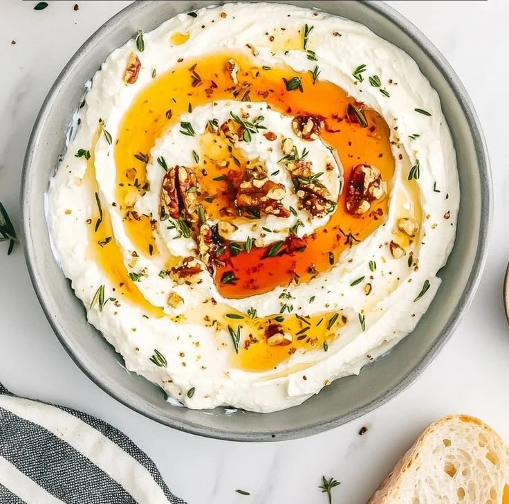 Delicious ricotta dip drizzled with hot honey, served in a bowl with crackers