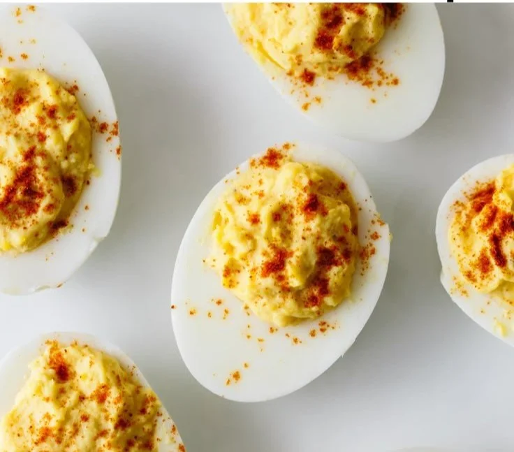 A platter of beautifully garnished deviled eggs ready to serve.