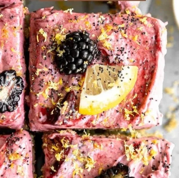 Gluten free lemon poppy seed blackberry cake topped with fresh blackberries.