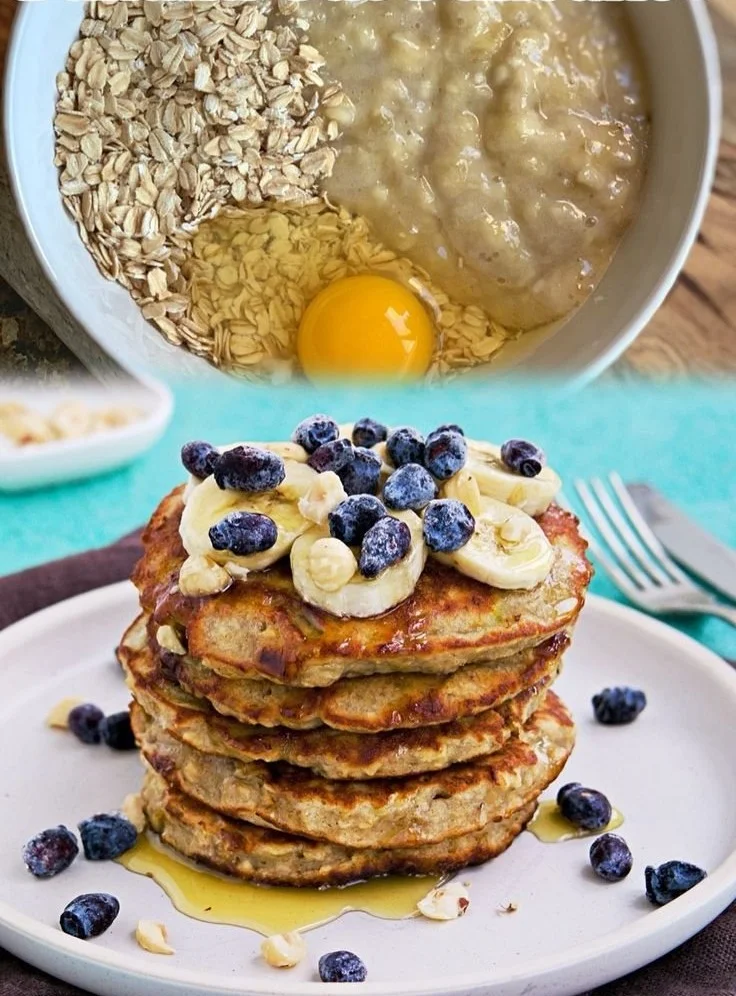 Healthy banana oatmeal pancakes stacked on a plate with syrup and banana slices.