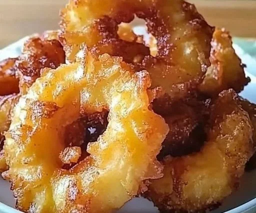 Delicious pineapple fritters served with a sprinkle of powdered sugar