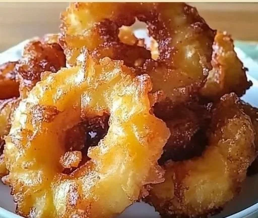 Delicious pineapple fritters drizzled with syrup.