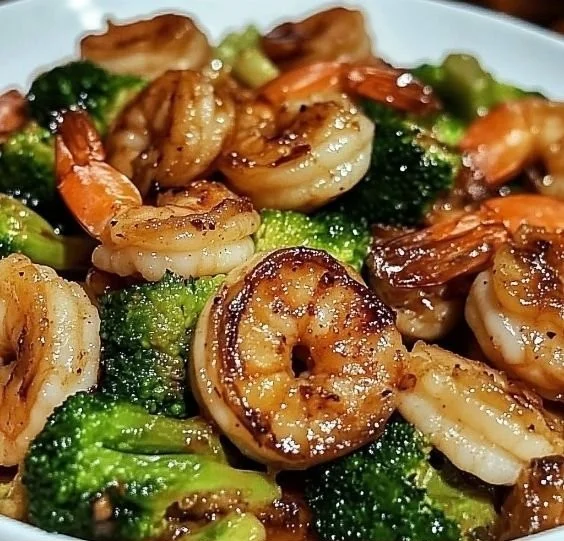 High-protein honey garlic shrimp dish garnished with herbs and served on a plate.