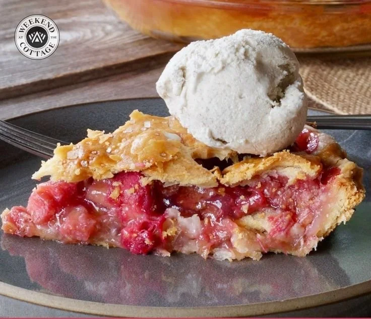 Homemade rhubarb pie fresh out of the oven on a rustic table