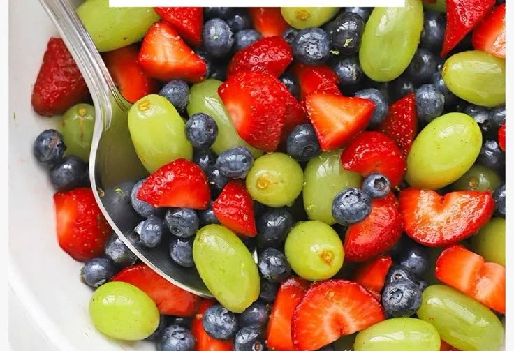 Colorful honey lime fruit salad with mixed fresh fruits in a bowl