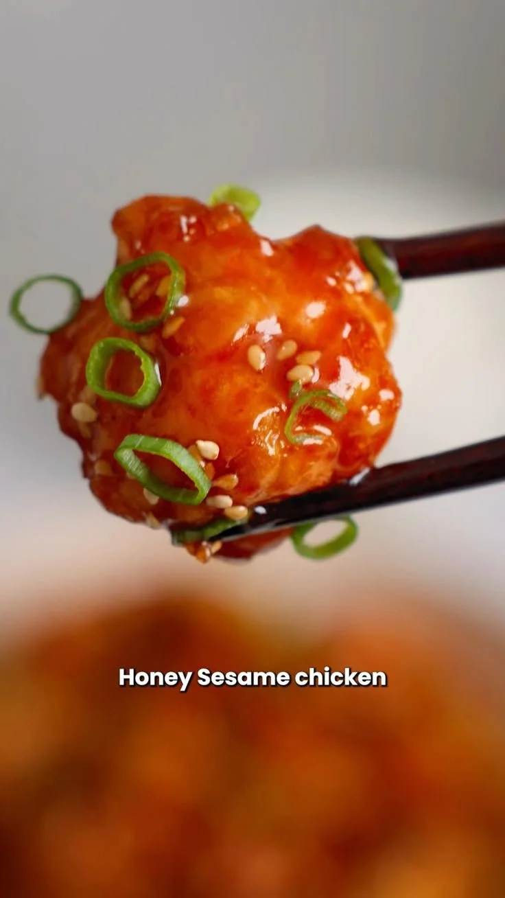Plate of Honey Sesame Chicken garnished with sesame seeds and green onions