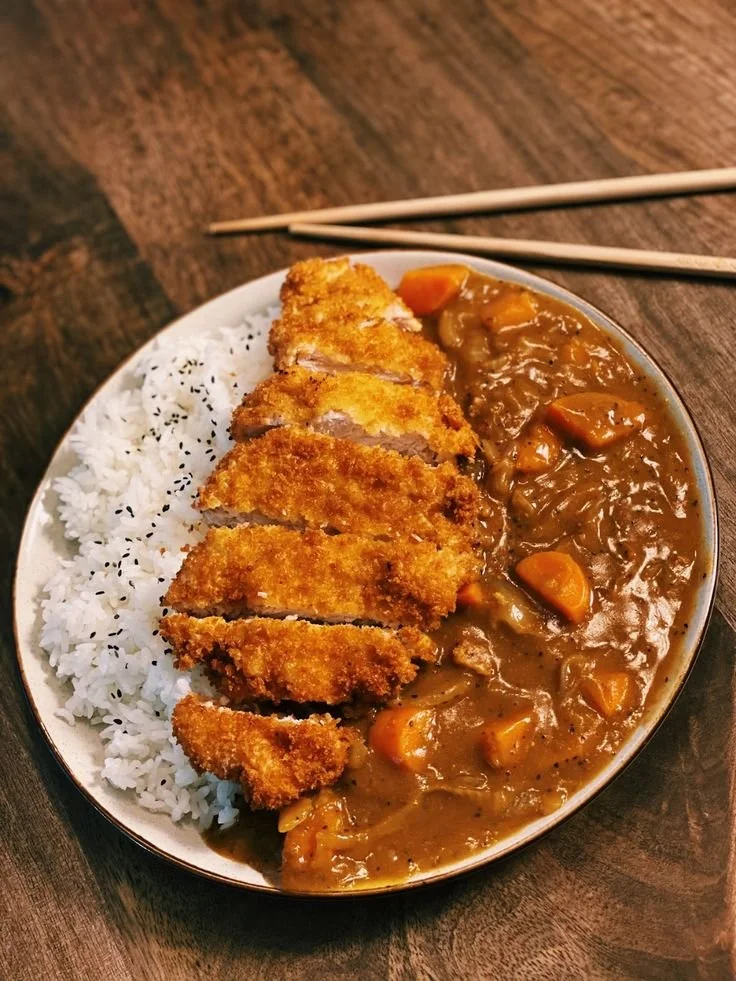 Delicious Japanese Pork Katsu Curry served with rice and vegetables.
