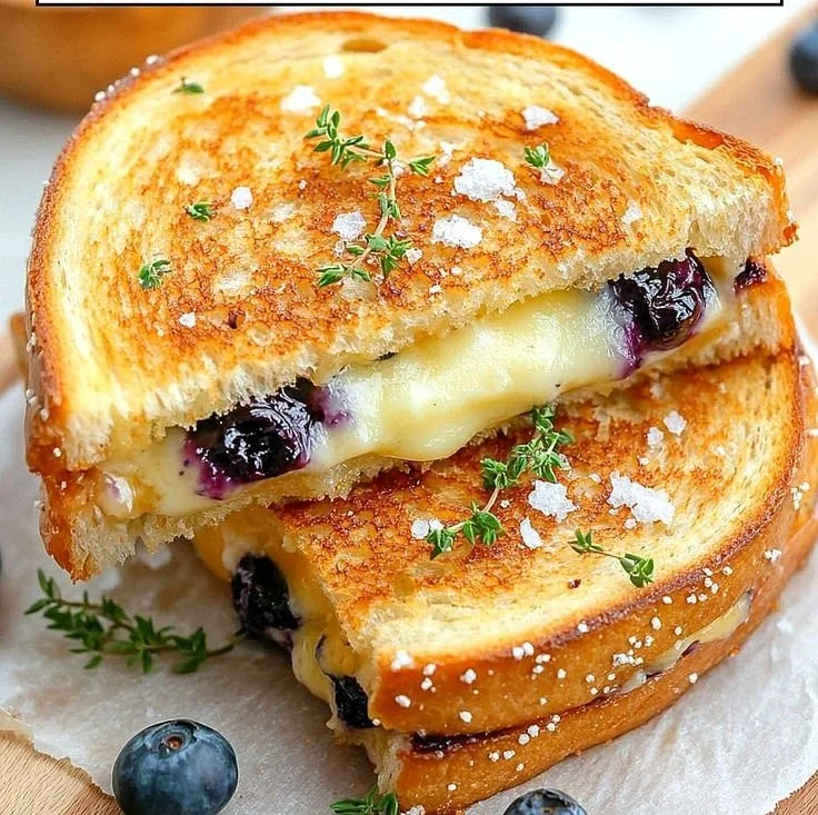 Juicy blueberry grilled cheese sandwich with melted cheese and fresh blueberries