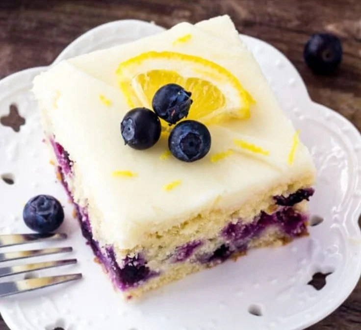 Lemon Blueberry Cake with fresh blueberries and lemon zest on a plate