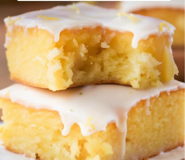 Delicious lemon brownies garnished with powdered sugar and lemon zest