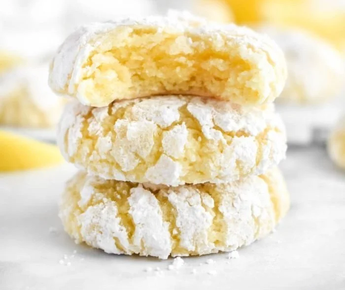 Freshly baked Lemon Crinkle Cookies dusted with powdered sugar