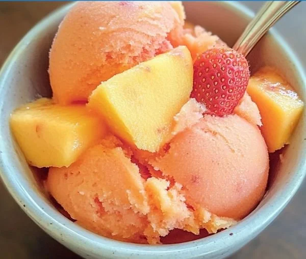 Delicious Mango Strawberry Sorbet in a bowl garnished with fresh fruit